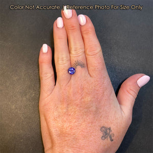 size of round tanzanite gemstone on hand 