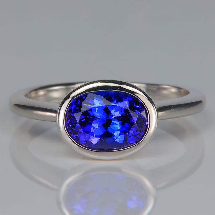 oval cut tanzanite gemstone is bezel set platinum ring