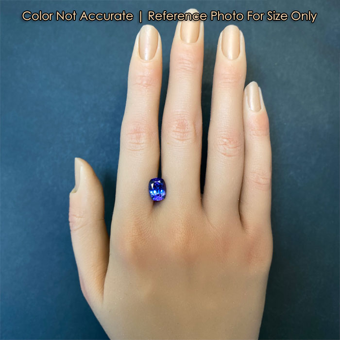 blue violet color tanzanite on hand