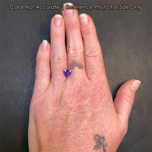 violet color tanzanite on hand