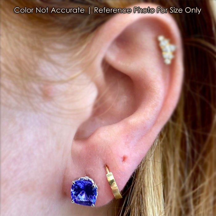 white gold tanzanite studs on ear