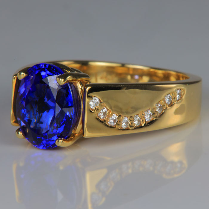 oval cut tanzanite gemstone ring in yellow gold with diamond accents