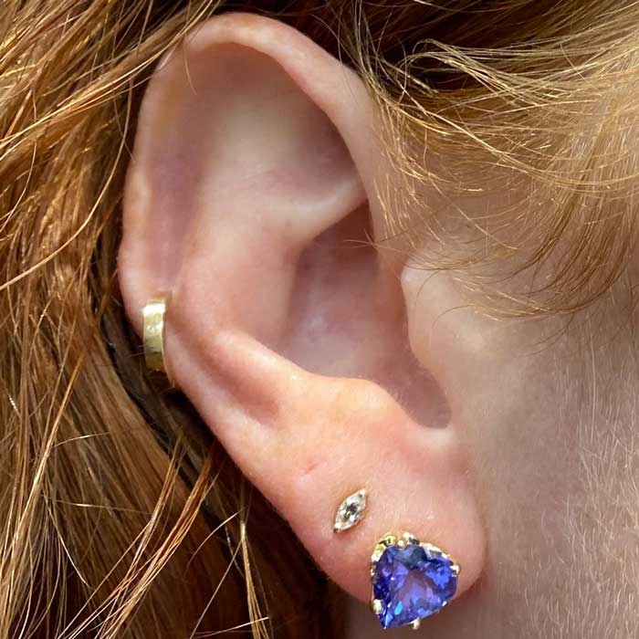 blue violet tanzanite heart studs on ear