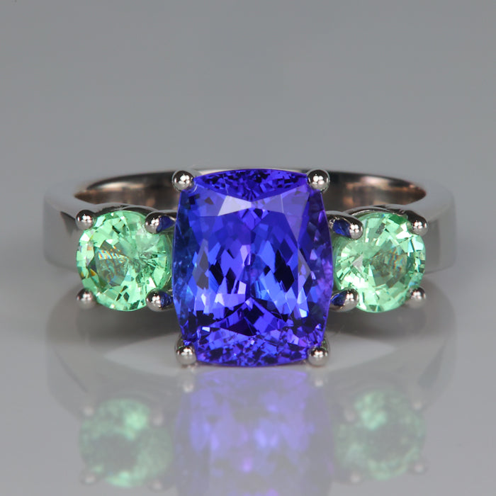 antique cushion cut tanzanite gem in platinum ring with garnets