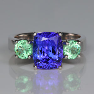 antique cushion cut tanzanite gem in platinum ring with garnets