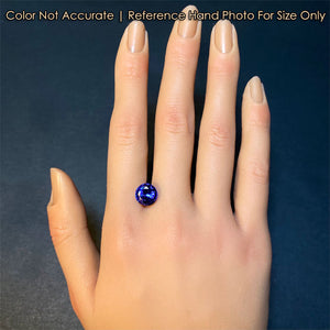 tanzanite gemstone on hand blue violet