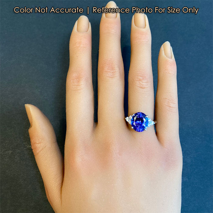 oval tanzanite and diamond ring on hand for size reference