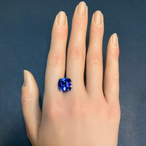 large tanzanite gemstone on hand