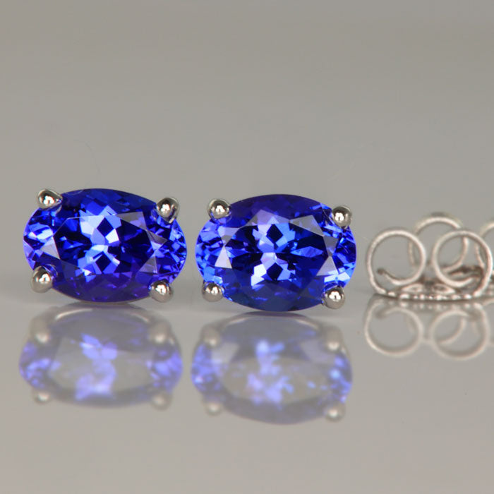 Oval four prong tanzanite earrings in 14k white gold