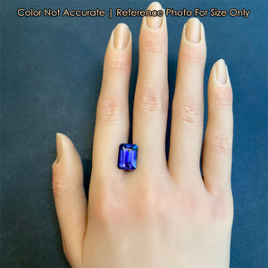 emerald cut blue violet tanzanite on hand