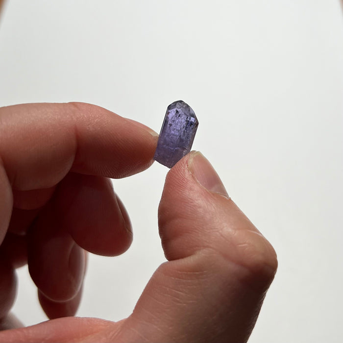 natural tanzanite crystal in hand