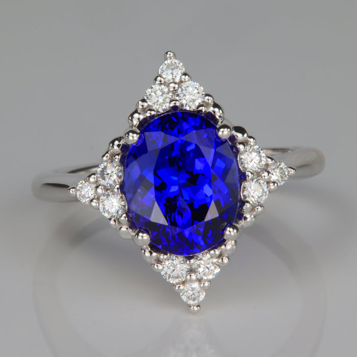oval cut mostly blue tanzanite and diamond ring in white gold