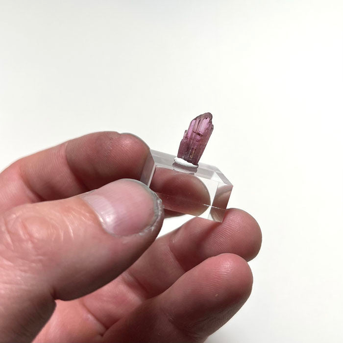rare pink tanzanite crystal in hand