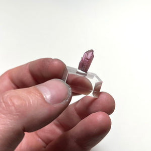 rare pink tanzanite crystal in hand