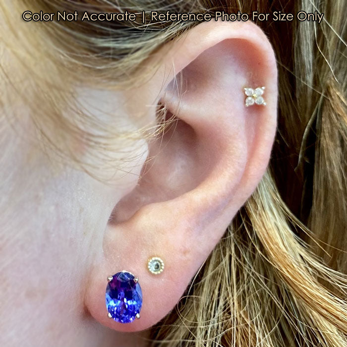 white gold oval tanzanite earrings on ear