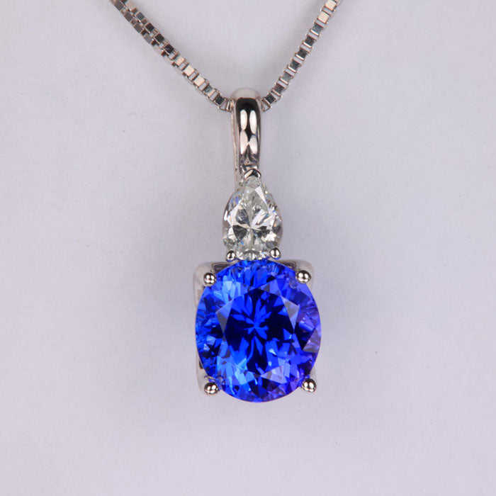 oval tanzanite with pear shape diamond pendant white gold