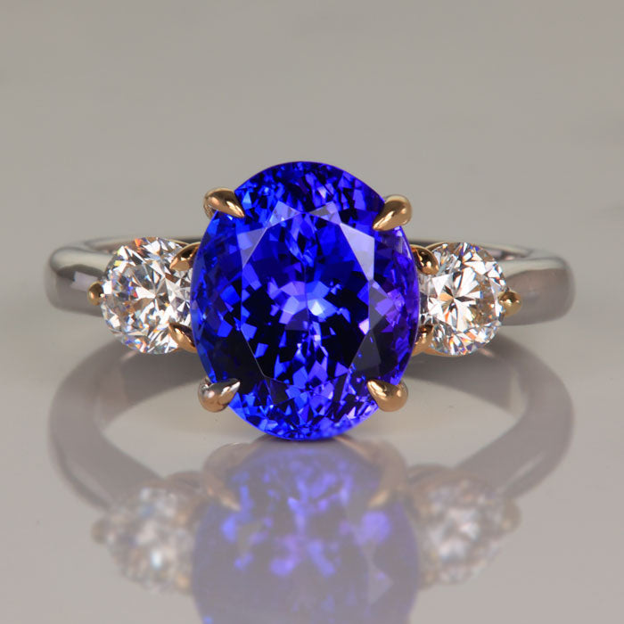 oval cut tanzanite and diamond ring in white and yellow gold