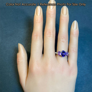 tanzanite gemstone ring with sapphire accents and diamonds in white gold size to a hand
