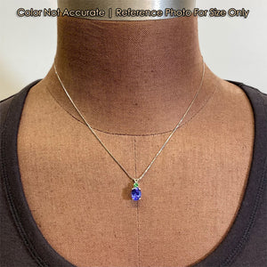 white gold oval tanzanite and tsavorite garnet pendant on bust