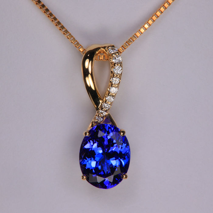 blue violet tanzanite gemstone pendant in yellow gold with diamond accents