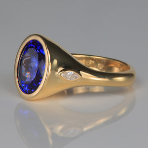 oval tanzanite and marquise diamond ring in yellow gold