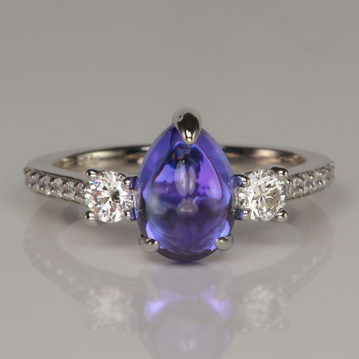 pear shape cabochon cut blue violet tanzanite gemstone ring with diamonds in platinum