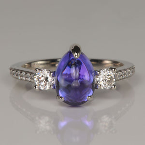 pear shape cabochon cut blue violet tanzanite gemstone ring with diamonds in platinum