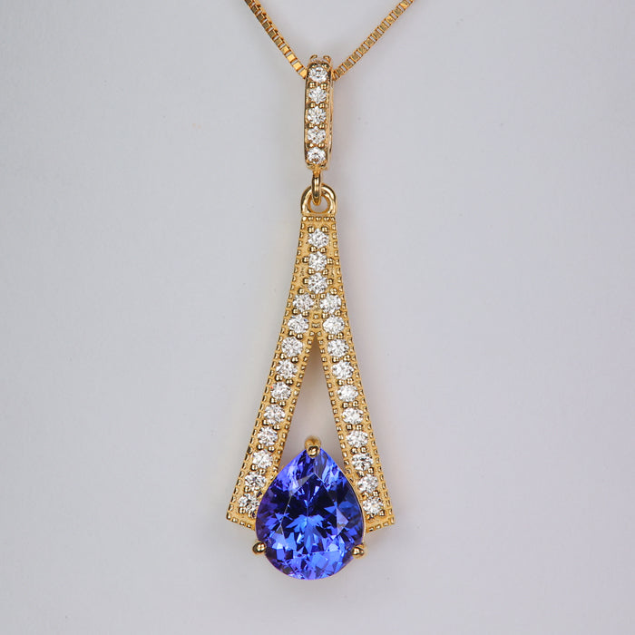 pear shape brilliant tanzanite gemstone in yellow gold pendant with diamonds