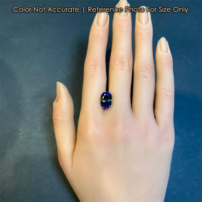 oval bicolor tanzanite gemstone size to a hand
