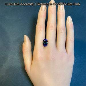 oval bicolor tanzanite gemstone size to a hand