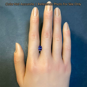 oval tanzanite gemstone on a hand