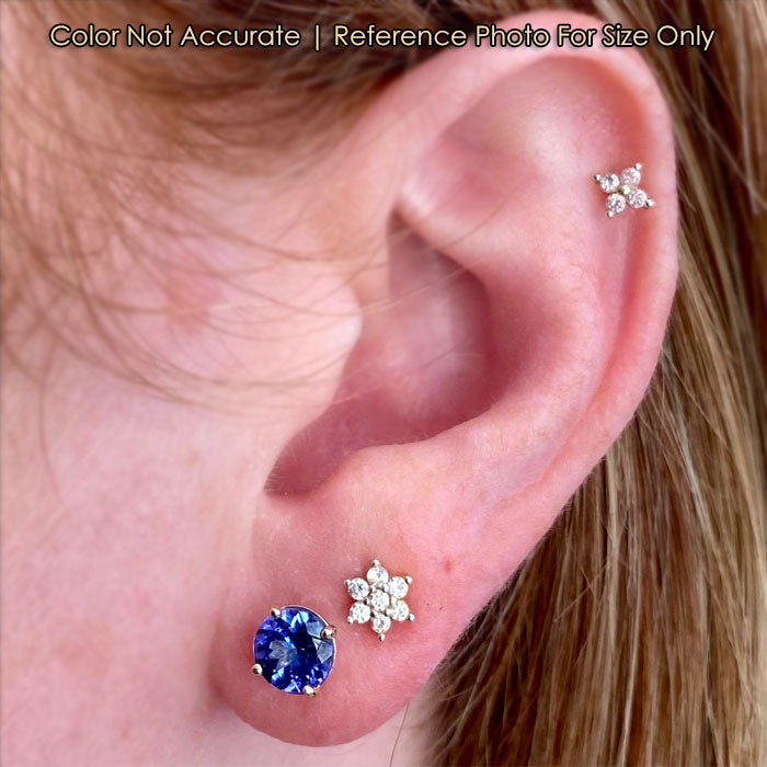 yellow gold tanzanite stud earrings on ear