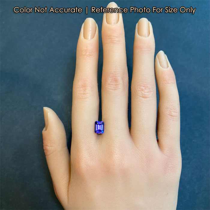 blue violet tanzanite gem on hand
