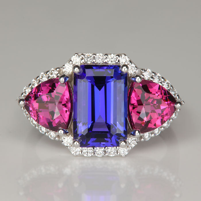 emerald cut tanzanite gemstone ring with umbalite garnets and diamonds in white gold