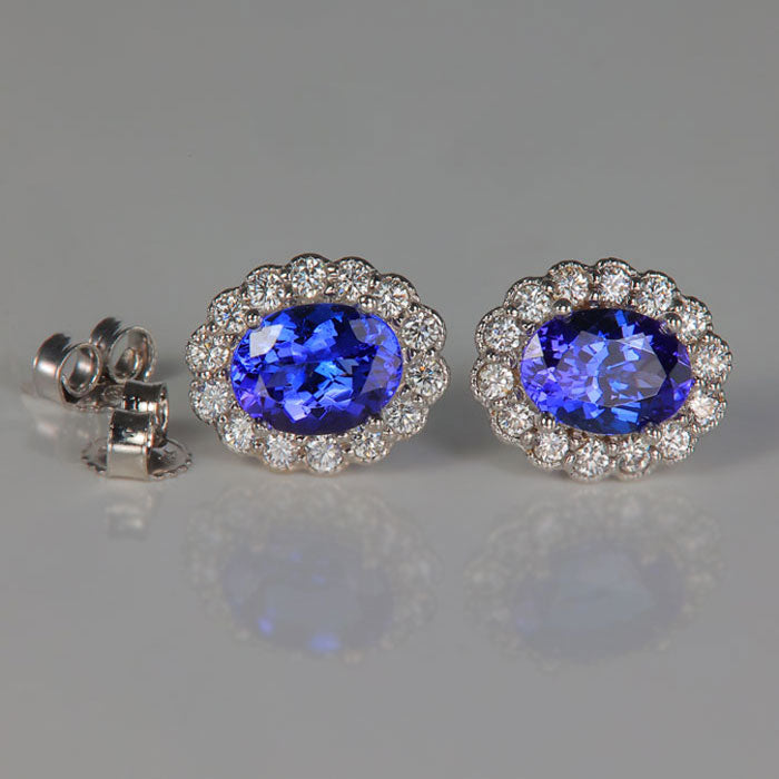 white gold tanzanite and diamond halo earrings