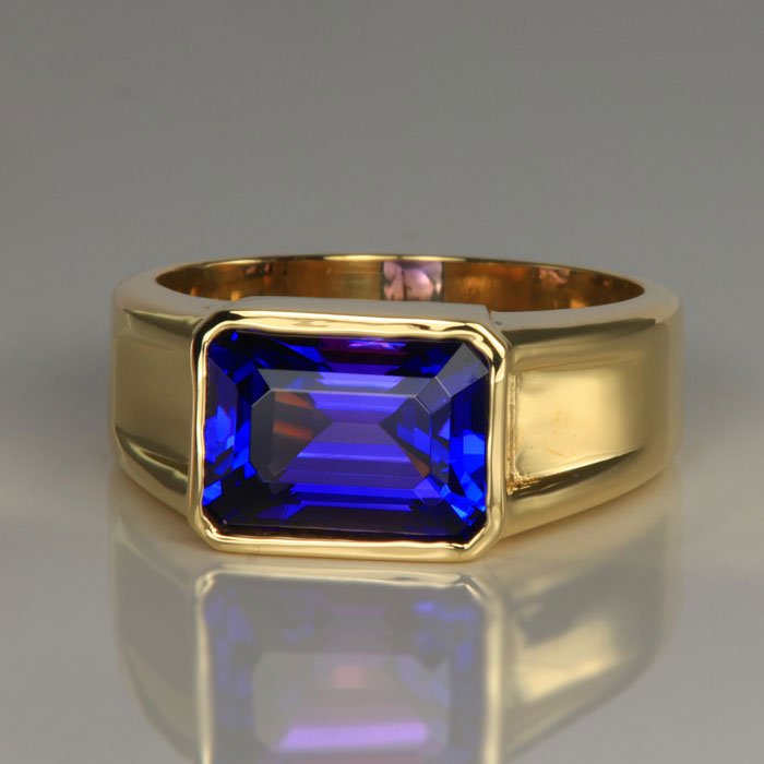 emerald cut tanzanite bezel set mens ring yellow gold