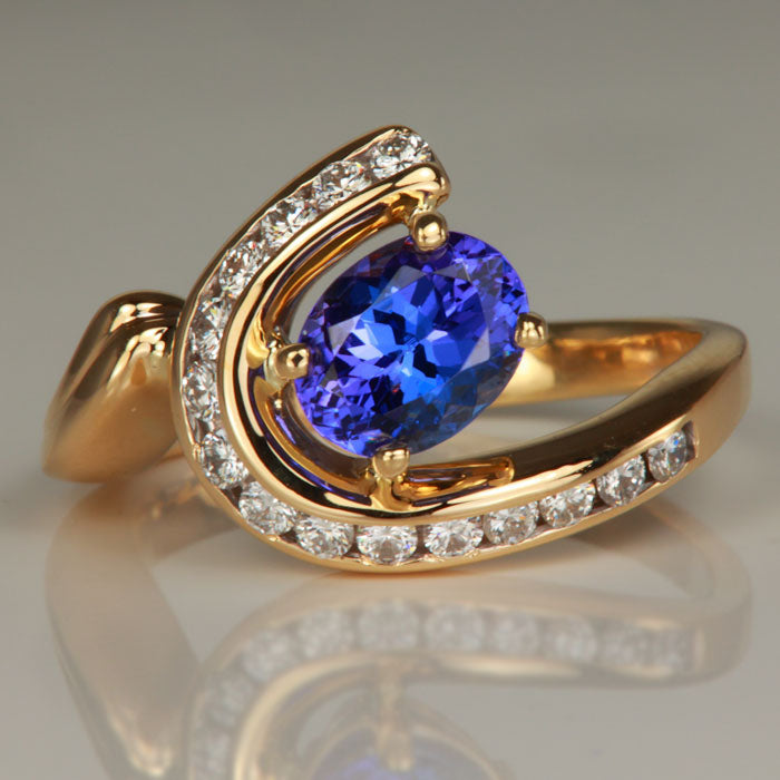 oval cut tanzanite and channel set diamond ring yellow gold