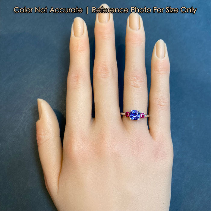 white gold tanzanite and ruby ring on hand
