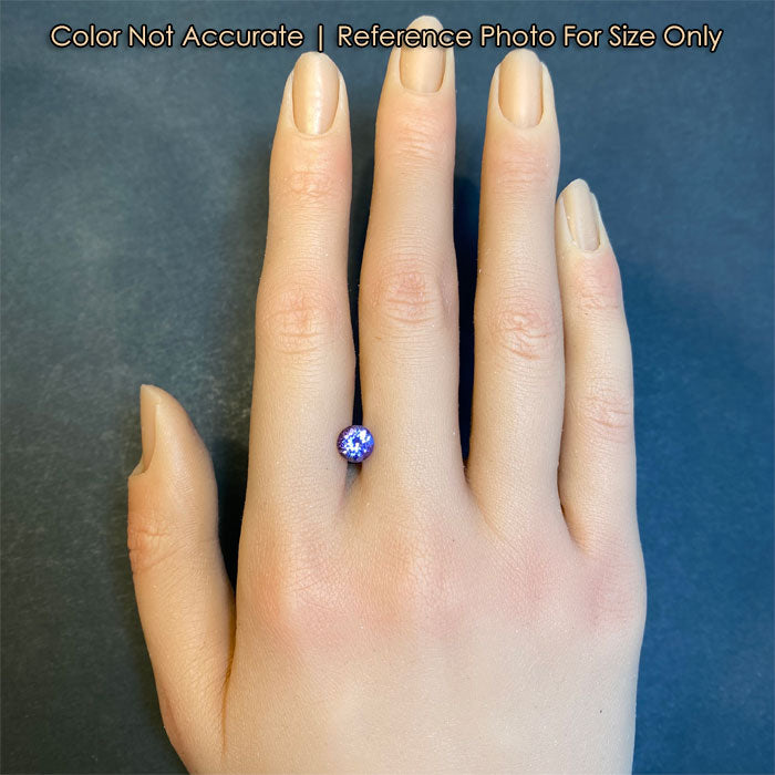 round tanzanite on hand gemstone 