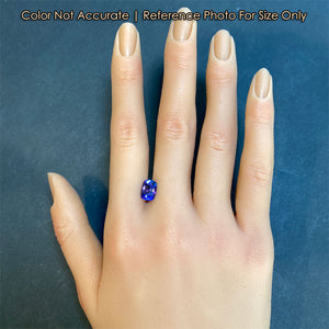 violet blue tanzanite gemstone on hand size