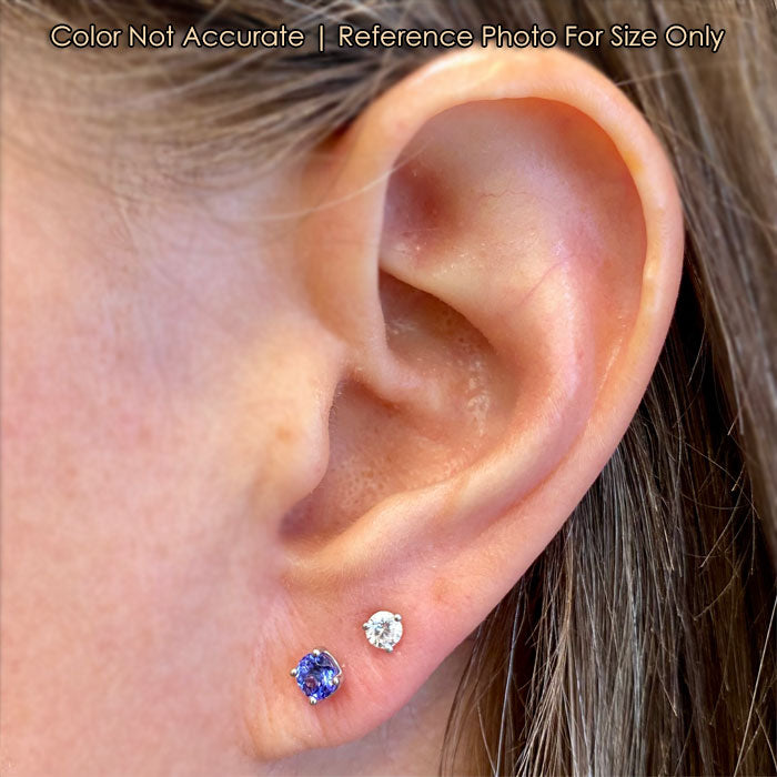 white gold tanzanite gem earrings on ear