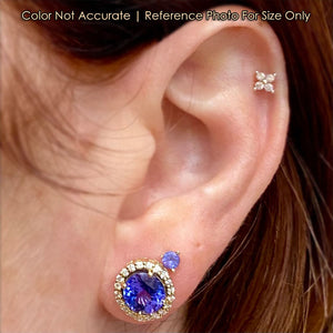 yellow gold tanzanite studs on ear