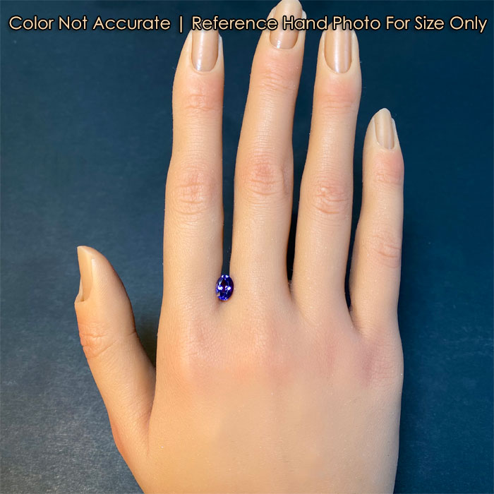 oval tanzanite gem on hand