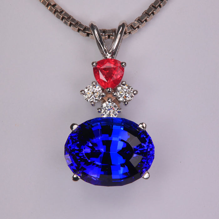 tanzanite gemstone pendant with diamonds and ruby in white gold