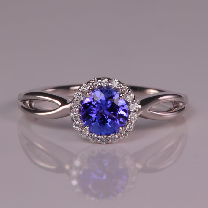 round brilliant tanzanite and diamond halo ring in white gold 