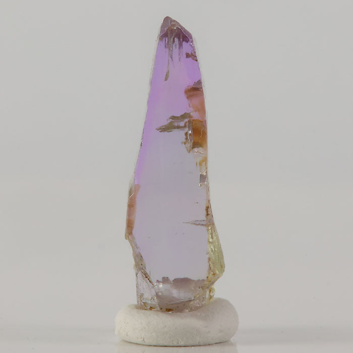 raw tanzanite crystal specimen with pink and yellow