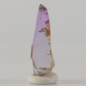 raw tanzanite crystal specimen with pink and yellow