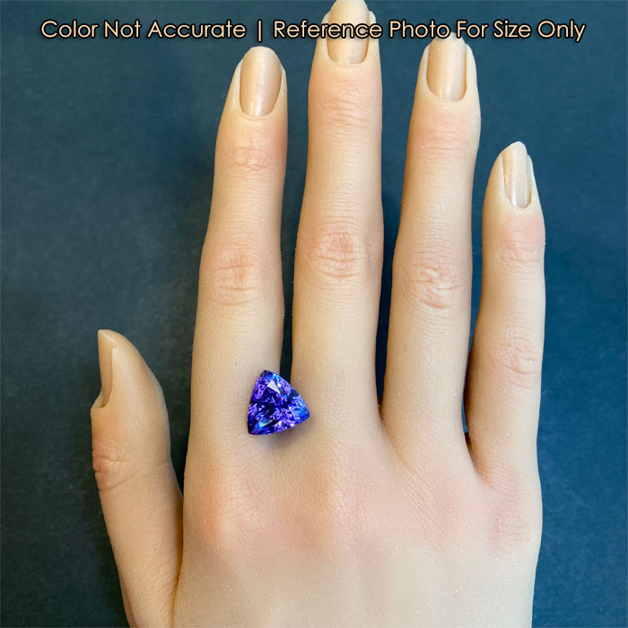 blue violet trilliant tanzanite gem on hand