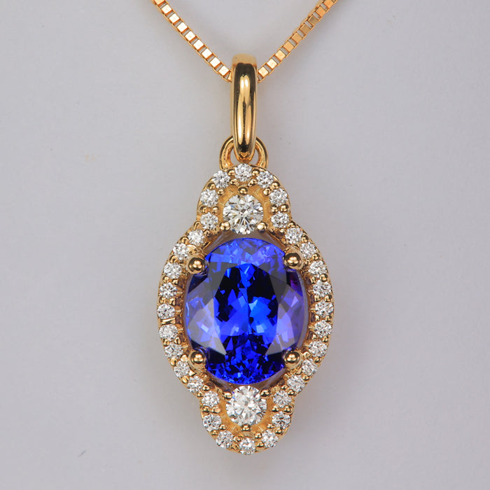 oval tanzanite gemstone in yellow gold pendant with diamonds 