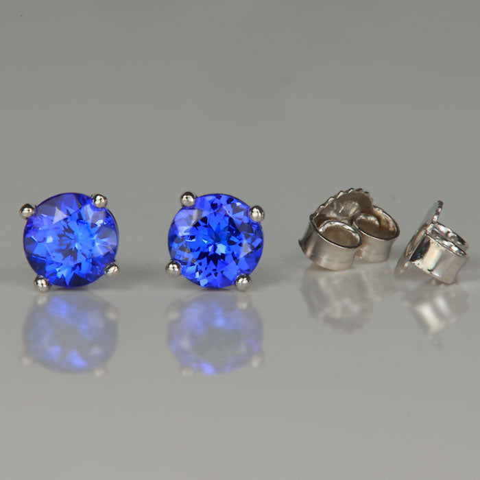 white gold mostly blue tanzanite round brilliant cut stud earrings 